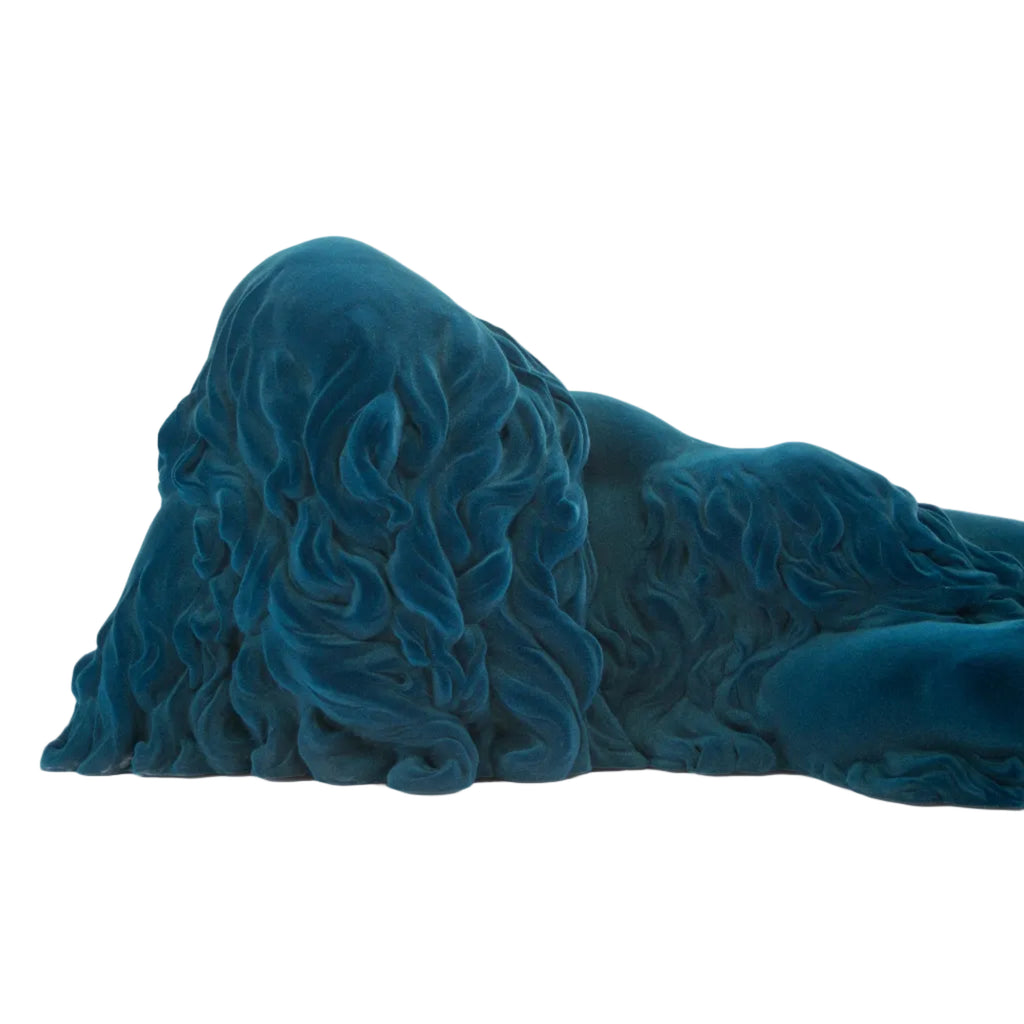 A sculptural, draped textile or blanket with a wavy, flowing texture in a deep teal blue color, photographed on a seamless white background.